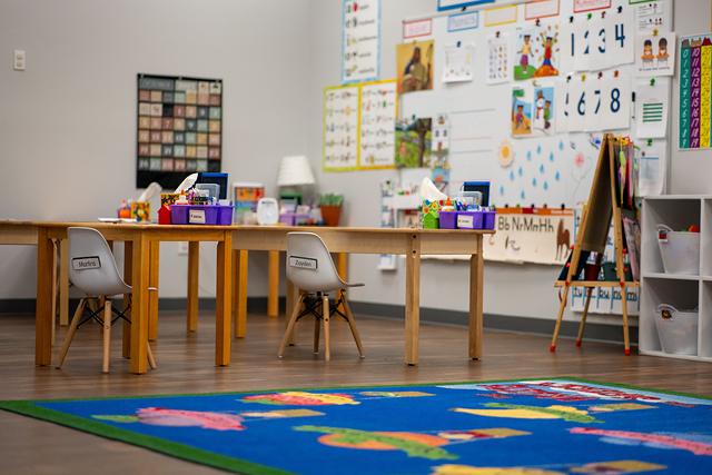 Classroom tables, an easel and an ocean-animal rug