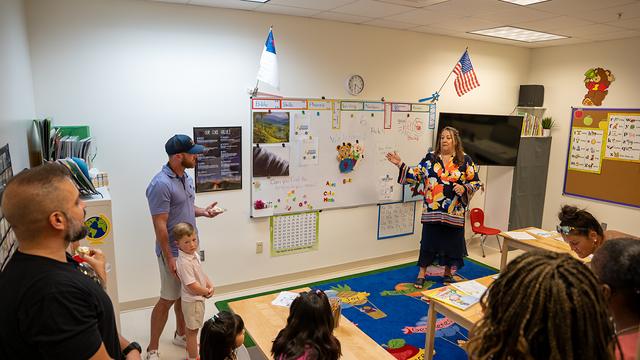 Parents and children listening to a talk in a classroom